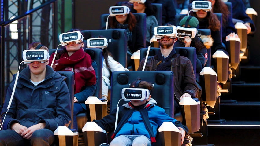 people setting in theatre weared VR headsets